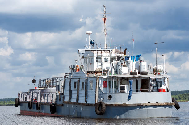 istock River fuel tanker on the river, cloudy blue sky 1206467105