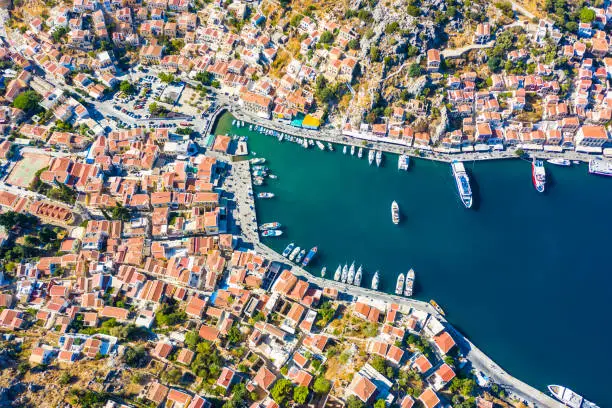 incredible view from the drone of the Bay and the houses of the Greek island. colorful houses, yachts and boats on the pier. Greece Europe