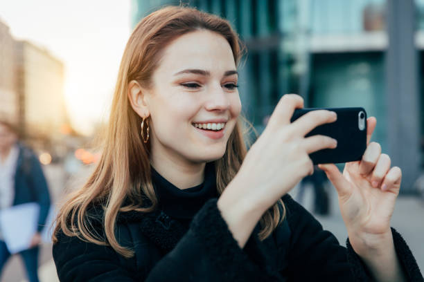istock young woman taking mobile photo 1206472982