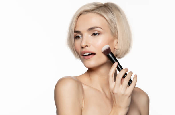 istock beautiful woman with  makeup brush 1206473000