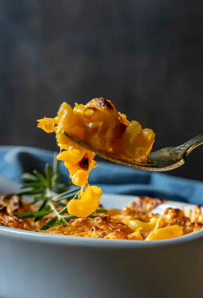 Photo of Macaroni and cheese in white baking dish.