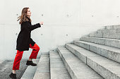 Woman climbing up the stairs