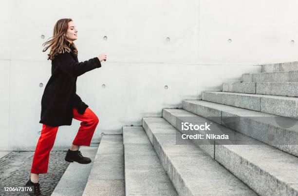 Woman Climbing Up The Stairs Stock Photo - Download Image Now - Staircase, Steps, Moving Up