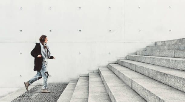 istock Woman climbing up the stairs 1206473188