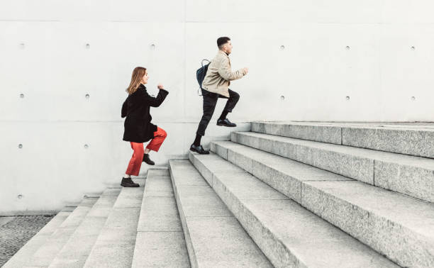 istock two friends running up steps in urban setting 1206473203