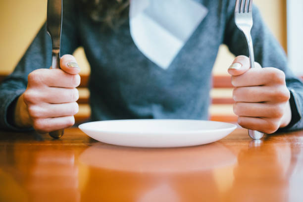 istock Young woman sitting at table in restaurant 1206479985