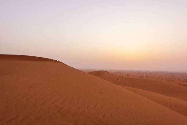 istock Beautiful Desert Sand dunes and rock formation with red sand pattern 1206481524