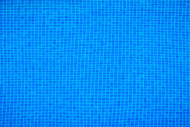 istock Pool with pure blue water background. Panorama of pool bottom with fine tile pattern. Top view of full swimming pool and floor texture. 1206484209