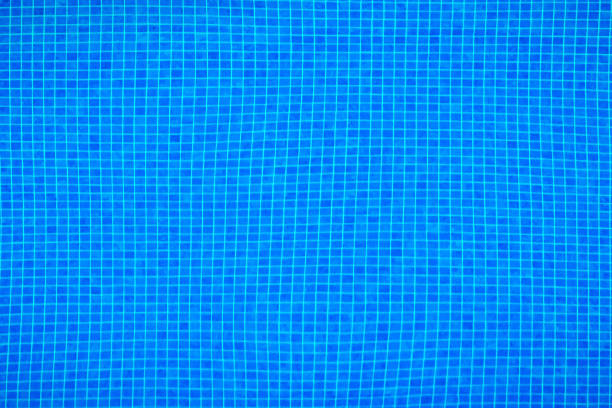 pool with pure blue water background. panorama of pool bottom with fine tile pattern. top view of full swimming pool and floor texture. - blue water swimming pool sports and fitness imagens e fotografias de stock