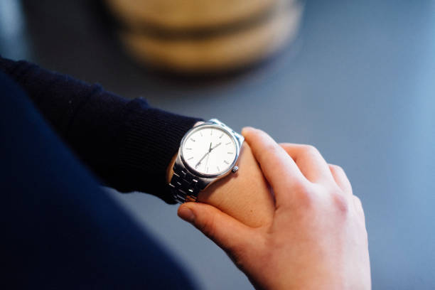 istock Woman checking time on her wrist watch in an office space 1206485463