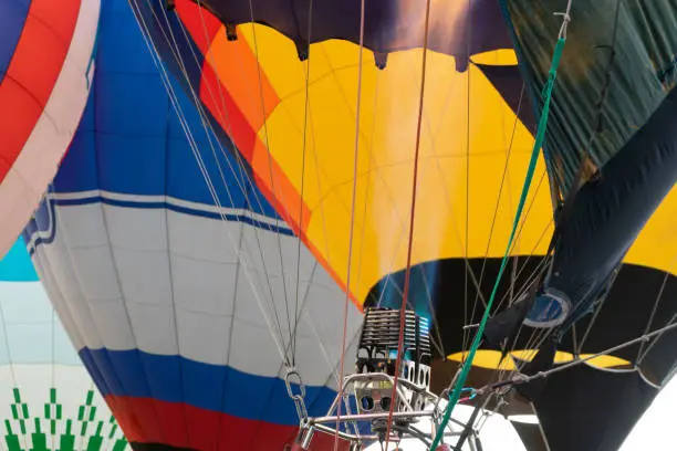 Fire warms the air in a balloon. Balloonists prepare the balloons for flight. Festival of aeronautics