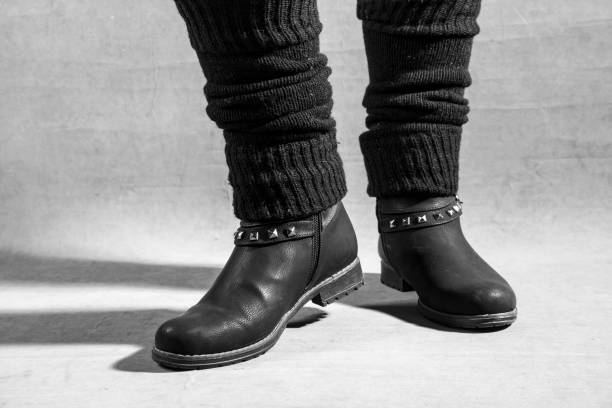 istock Feet dressed in black female boots. studio shoot, black and white photo 1206489681