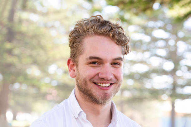 istock Portrait of smiling modern young man looking at camera, background with copy space 1206494157
