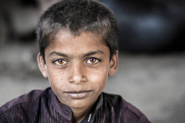 istock a young an innocent orphan sick boy is smiling 1206495253