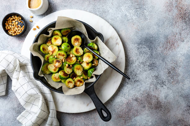 istock Roasted, fried, grilled crispy brussels sprouts with pine nuts, salt and pepper 1206495696