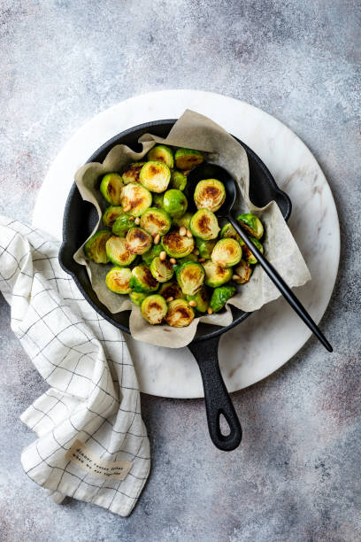 istock Roasted, fried, grilled crispy brussels sprouts with pine nuts, salt and pepper 1206495722