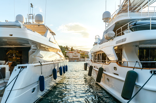 Motorboats rest tranquilly in the harbor of Rovinj,Croatia,against the clear sky during the serene sunset. The scene captures the calm beauty of the Adriatic