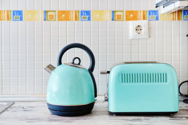 Toaster and electric kettle Close up view on work top two objects set, toaster electrical device for making toast and electric kettle electrical appliances menthol color modern technology easy quick fast usage, no people toaster appliance stock pictures, royalty-free photos & images