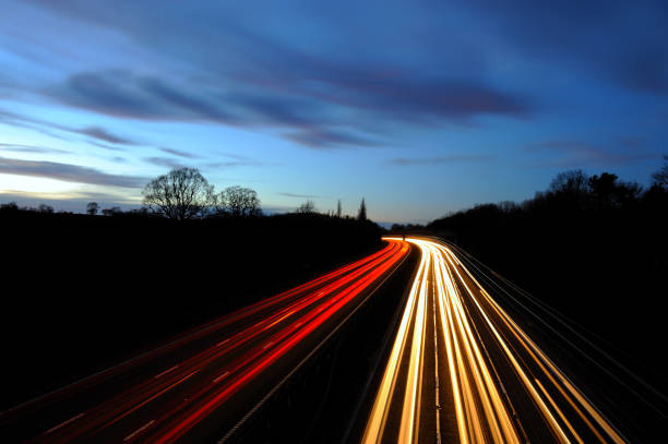 istock Long exposure wide angle view of motorway at dusk light trails 1206501467