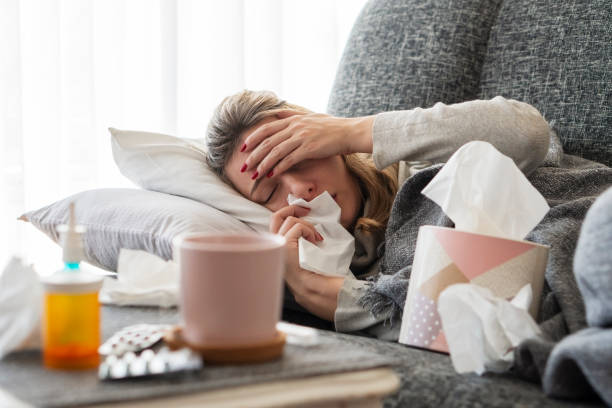 istock Sick woman with flu at home 1206504338