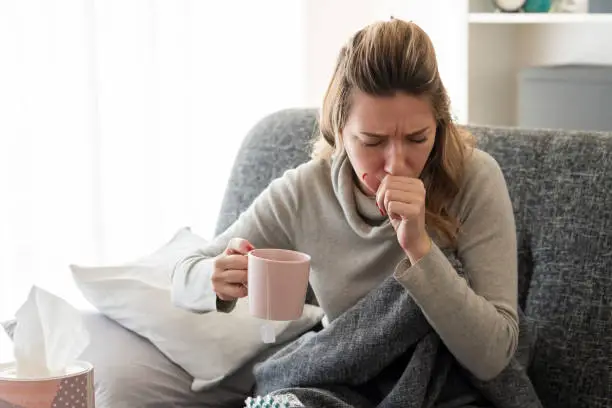 Sick woman with flu at home.