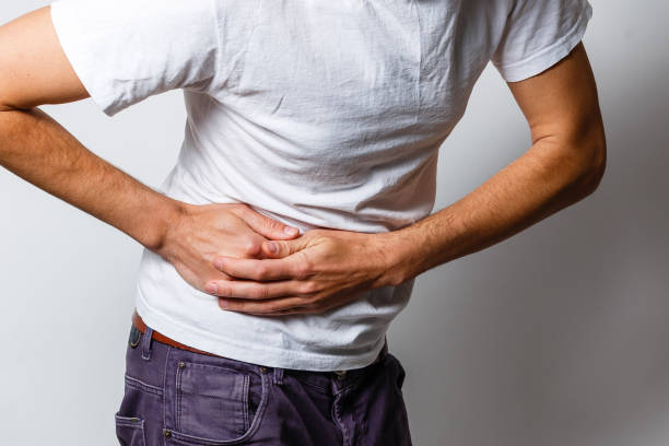 istock Young man with severe stomachache holding his stomach 1206507652