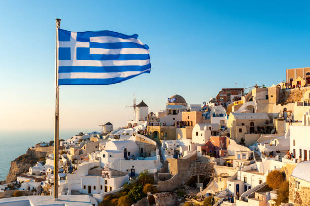 istock Oia Sunset and Greek Flag, Santorini, Greece 1206509311
