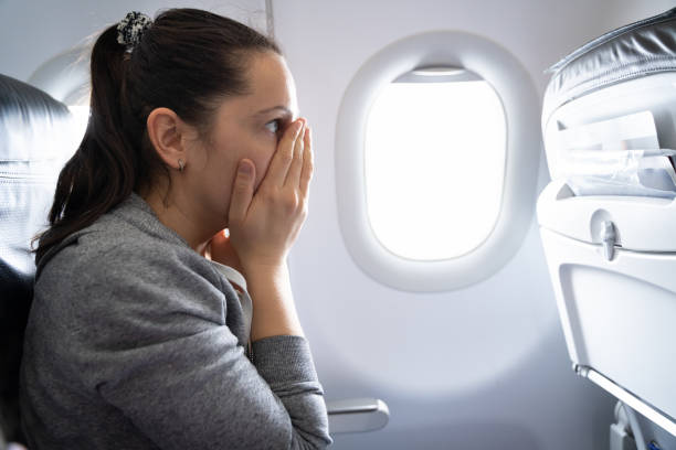istock Woman Having Anxiety Attack In Airplane 1206509377