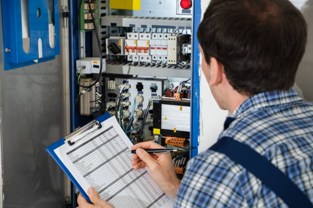 istock Electrician Holding Clipboard While Examining Fusebox 1206509507