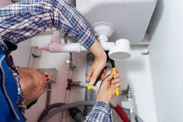 istock Male Plumber Fixing Sink In Bathroom 1206509617