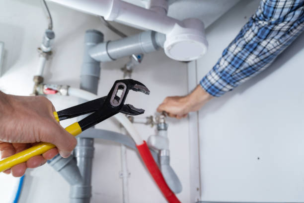 istock Male Plumber Fixing Sink In Bathroom 1206509624