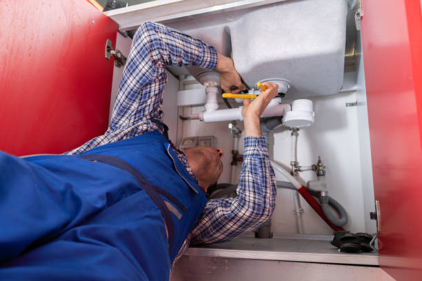 istock Male Plumber Fixing Sink In Bathroom 1206509625