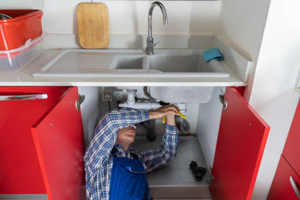 istock Male Plumber Fixing Sink In Bathroom 1206509632