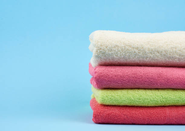 istock stack of colored cotton terry folded towels on a blue background 1206510795