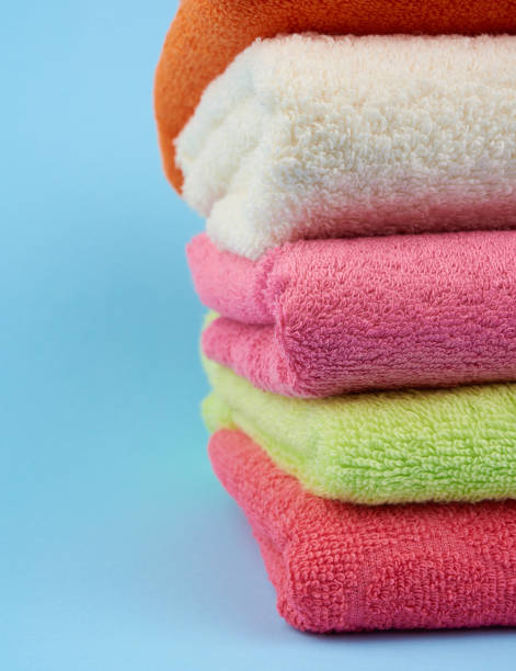 istock stack of colored cotton terry folded towels on a blue background 1206513179
