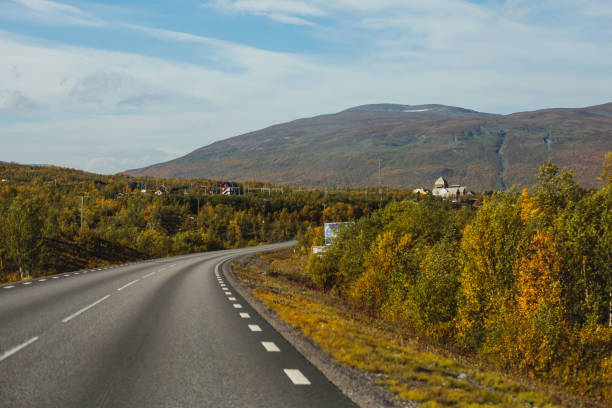 Sunny fall autumn view of Abisko National Park, Kiruna Municipality, Lapland, Norrbotten County, Sweden, with Abiskojokk river, road and Nuolja mountain, near border of Finland, Sweden and Norway Sunny fall autumn view of Abisko National Park, Kiruna Municipality, Lapland, Norrbotten County, Sweden, with Abiskojokk river, road and Nuolja mountain, near border of Finland, Sweden and Norway"n norrbotten province stock pictures, royalty-free photos & images