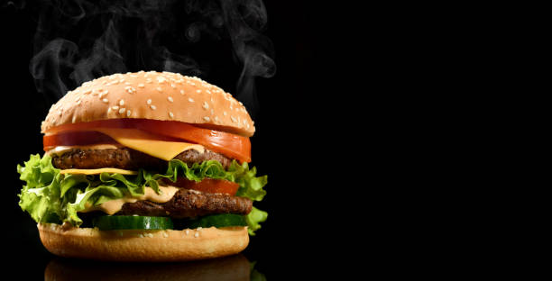 istock Double burger cheeseburger barbeque sandwich with beef  cheese and fresh vegetables hot with steam smoke on black 1206521330