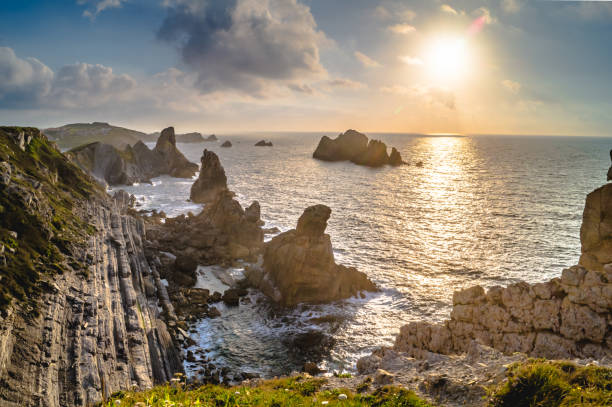 istock Sunset with sun, clouds and calm sea on cliffs of Costa Quebrada 1206525423