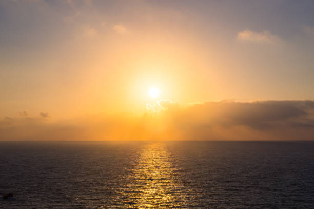 istock Sunset with sun, clouds and calm sea on cliffs of Costa Quebrada 1206525480