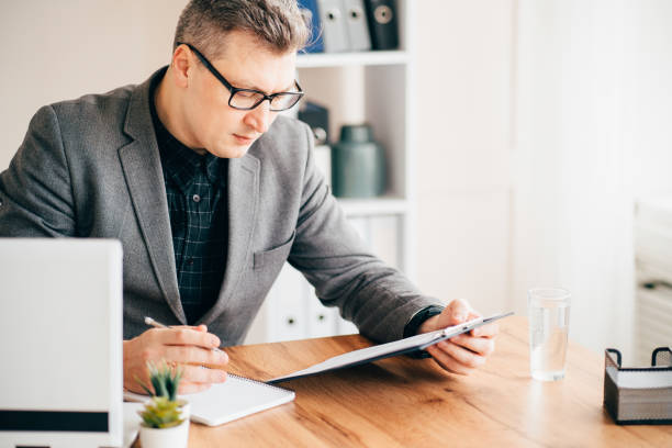 istock Businessman or expert analyzing business report 1206526434