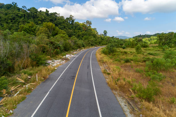 istock Asphalt road curve with yellow line on road image by drone camera high angle view. 1206529593