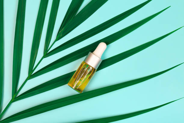 istock bottle of essential oil on blue background 1206531775