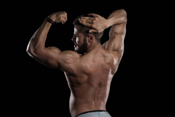istock Muscular Man Flexing Muscles On Black Background 1206531805