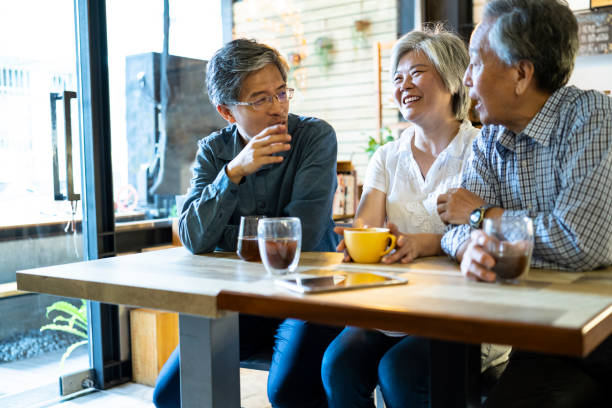 istock Asian family sitting in cafe having fun and talking 1206531959