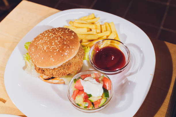 istock Mini Burger platter with fries Salad on the table. 1206532895