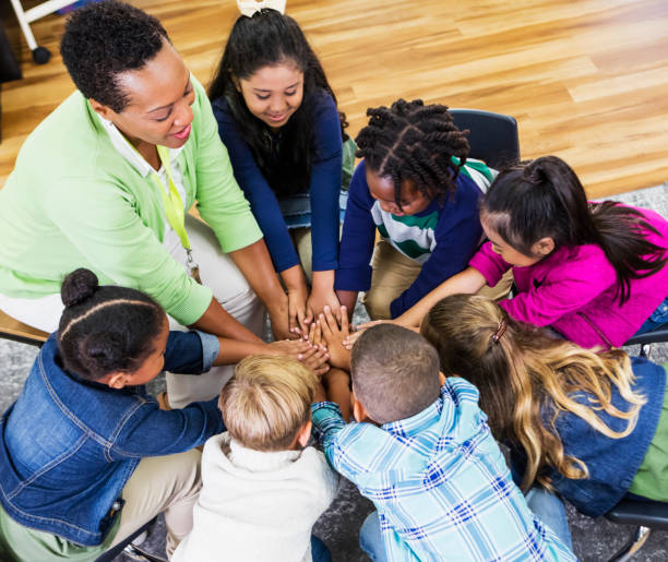 istock Elementary school teacher and children work together 1206534814