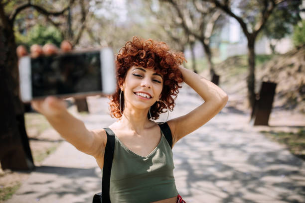 istock Cute Hispanic Redhead Woman Making A Selfie 1206535542