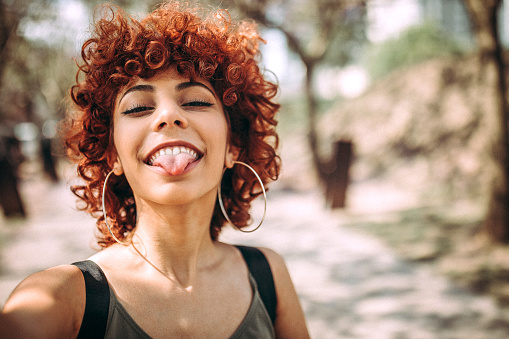 Cute Hispanic Redhead Woman Making A Selfie