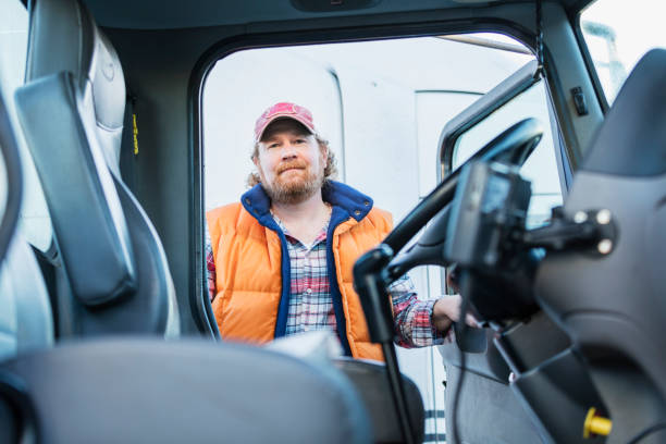 istock Trucker driver climbing into his semi-truck 1206536642