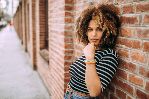 istock Cute Hispanic woman posing on brick wall 1206536672